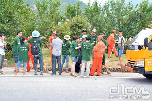 记者团冒着高温现场采访小顺公路站一线养路工人