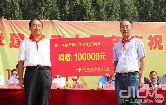 图为常柴希望小学校长尹士烨（左）接受常柴的捐赠