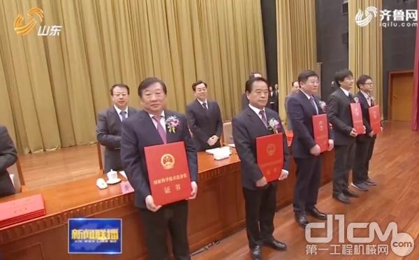 谭旭光代表潍柴动力“国家科技进步一等奖团队”，上台接受表彰。