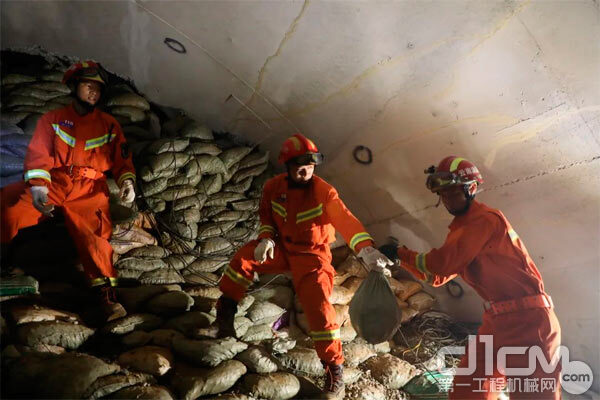 △救援人员正在搬运砂石袋对隧道顶部进行加固